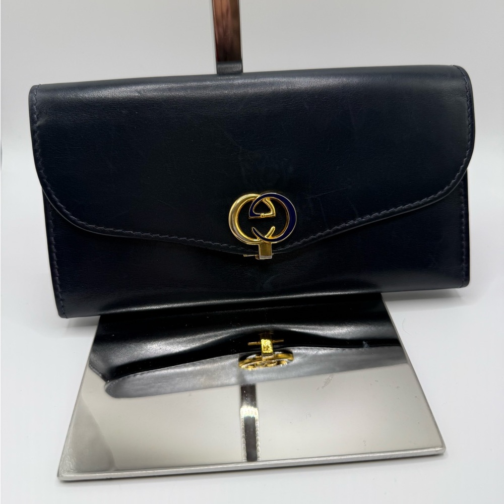 Gucci Midnight Blue Leather Wallet with Gold Emblem measures about 7in x 4 in.